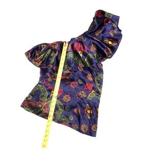 One shoulder blue top.